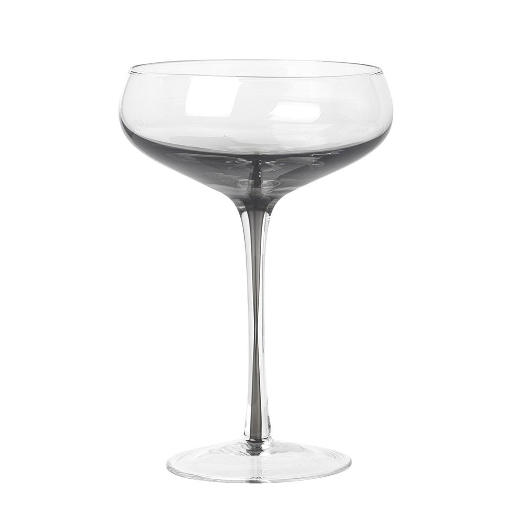Serve drinks in the beautiful smokey grey cocktail glass from the Danish brand, Broste Copenhagen. These hand blown wine glasses have a smokey grey bottom which carries down through the centre of the stem, to give them an edge over plain glassware. They would look stunning on any table. Dimensions: 11cm diameter x 16cm high Volume: 200mls