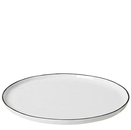 Elegant shaped plate from the Broste Copenhagen Salt dinnerware collection.   The dinner plate features a black hand painted brim making each piece unique.  Commercially rated dinnerware range made of porcelain.  Dimensions: 27cm diameter x 1.5cm high