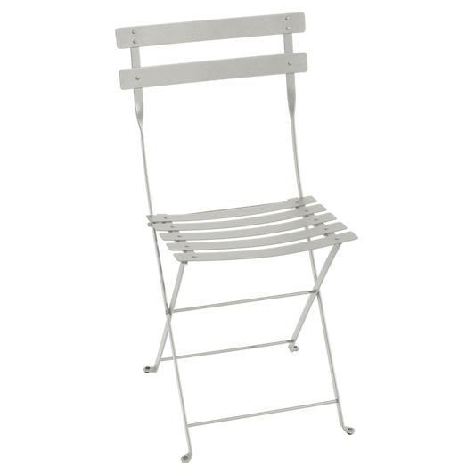 Classic outdoor folding bistro chair, made in France by the iconic French brand, Fermob.  The Bistro chair is designed to remain outdoors and is fully weather resistant. The chairs look great sitting around a small bistro table on a terrace or used them down a long banquet table under the vines! Dimensions: 38cm wide x 82cm high x 42cm deep  Colour: clay grey