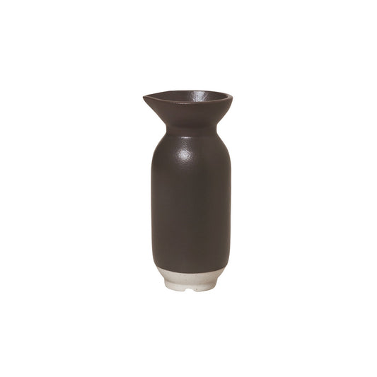 The Eli jug is a minimalistic piece characterised by its round edges and soft colours, which gives connotations to modern Japanese tableware.   Eli has an aesthetic utility and is designed in different glazes including matt and gloss, which gives it a playful touch where the reactive glaze creates an organic feel and ensures no two pieces are exactly alike.  Colour: chocolate (charcoal)   Dimensions: 12cm high    Capacity: 100ml 