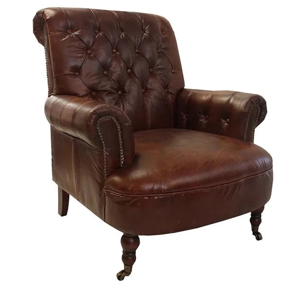 A classic and simple piece, this antique leather, buttoned back armchair will create a warm and inviting interior. Featuring metal studding detail along the front base of the arms, and caster wheels on the front legs. Colour: brown Dimensions: 88cm wide x 95cm long x 97cm high