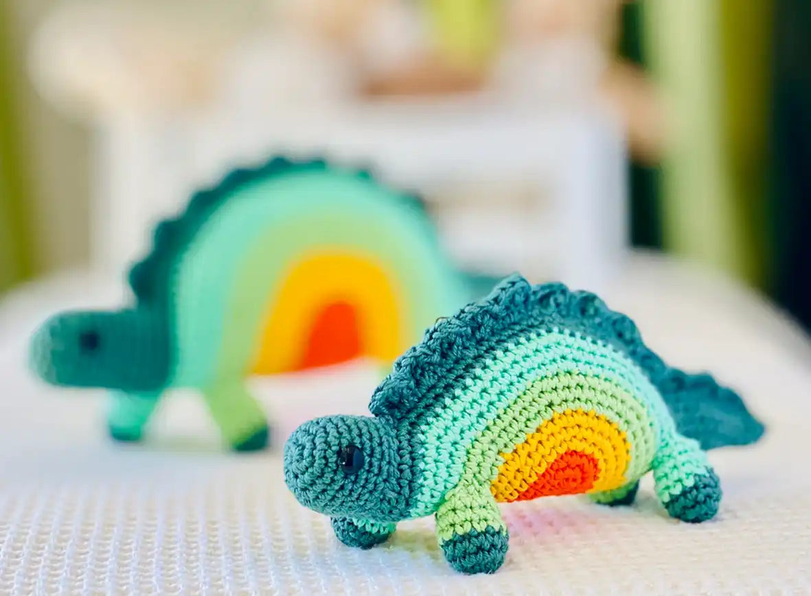 Fairtrade knit rainbow stegosaurus toy