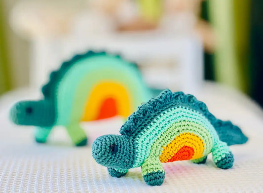 Fairtrade knit rainbow stegosaurus toy