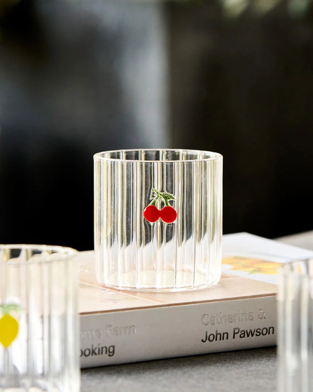 Glass tumbler with cherry motif