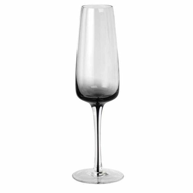 Simple and elegant champagne glass by Copenhagen design house Broste.   These hand blown wine glasses have a smokey grey bottom which carries down through the centre of the stem, to give them an edge over plain glassware. They would look stunning on any table.  Dimensions:  7cm diameter x 23cm high  Volume: 200mls