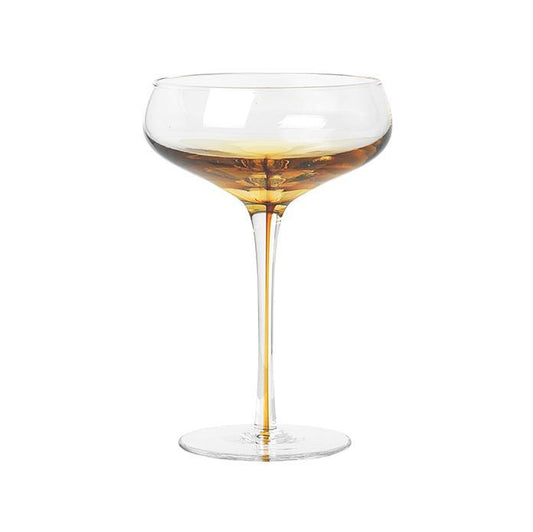 Serve drinks in the beautiful amber cocktail glass from the Danish brand, Broste Copenhagen.  This glass has a rich golden colour, inspired by amber, which makes the glass shine in warm honey tones.  Dimensions: 11cm diameter x 16cm high  Volume: 200mls