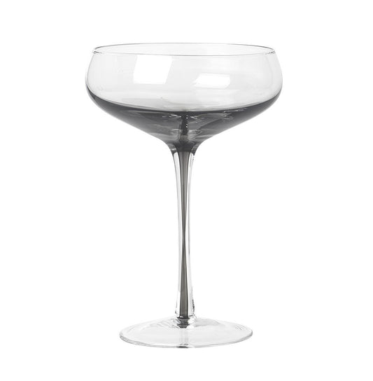 Serve drinks in the beautiful smokey grey cocktail glass from the Danish brand, Broste Copenhagen.  These hand blown wine glasses have a smokey grey bottom which carries down through the centre of the stem, to give them an edge over plain glassware. They would look stunning on any table.  Dimensions: 11cm diameter x 16cm high  Volume: 200mls