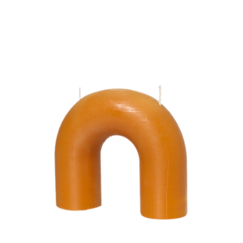 The Bend candle from Broste Copenhagen is a sculpturesque block candle with two wicks arranged in an arch-shaped design.  Dimensions: 16.5cm wide x 14.5cm high x 6cm deep  Please place the candle on a tray or plate.